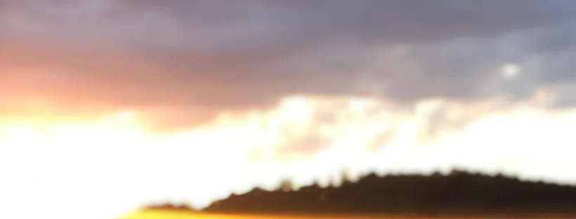 Example of a Facebook page cover photo at 820 x 312 pixels: a sunset sky with clouds over a dark tree line