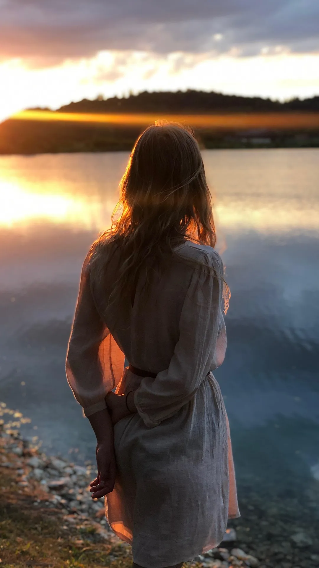 Example of a Facebook Story or Reel frame at 9:16, 1080 x 1920 pixels: a woman standing by a lake at sunset, with the top and bottom areas marked to keep clear